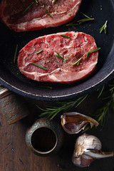 Pork steak with rosemary, garlic and pepper , top view