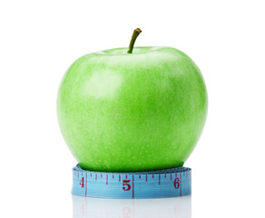 blue measure tape and green apple  isolated on white background