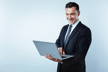 Joyful businessman working on computer