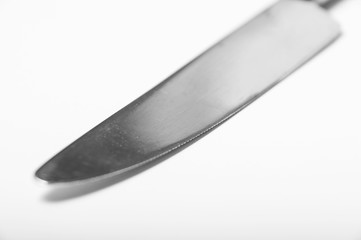 A single butter knife on a white background showing blade detail