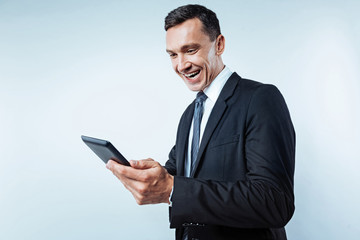 Radiant man of business using tablet computer