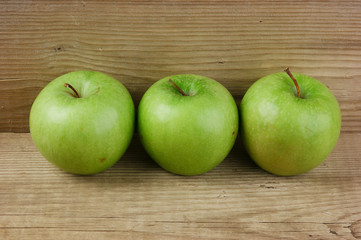 green apples on a wooden background
