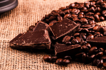 Dark chocolate lies on coffee beans