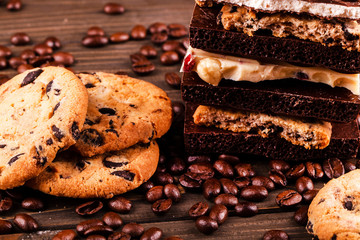 Chocolate cookies, dark and white chocolate on coffee beans