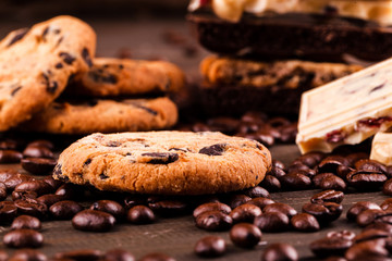 Chocolate cookies, dark and white chocolate on coffee beans