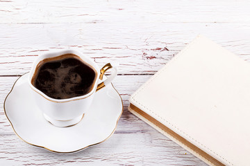 Porcelain cup with coffee on white table