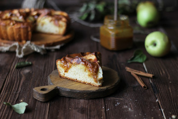 Apple pie with salted caramel on a wooden background