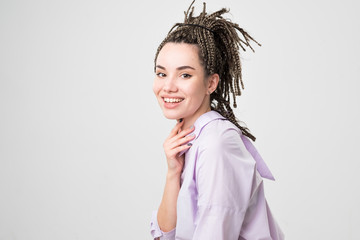 Woman smiling with perfect smile and white teeth. Her hair made in pigtails.