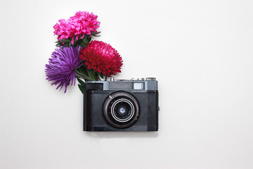 Creative photo of old vintage camera with peony flower