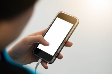 Cropped shot view of woman's hands holding smart phone with blank copy space screen for your text message or information content, female reading text message on cell telephone during in urban setting