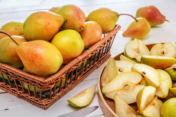 group of pears and half a pear on white wooden boards. Homework
