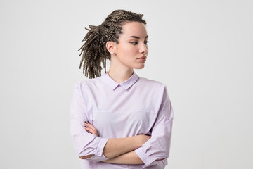 Half-length portrait of beautiful woman wearing white blouse looking aside.