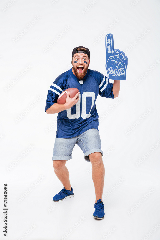 Wall mural Screaming man fan in blue t-shirt standing isolated