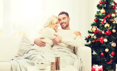 Obraz na płótnie Canvas happy couple at home with christmas tree
