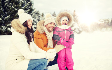 Fototapeta premium happy family with child in winter clothes outdoors