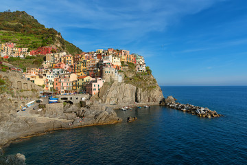Fototapeta na wymiar Magnificent daily view of the Manarola village in a sunny summer day. Manarola is one of the five famous villages in Cinque Terre (Five lands) National Park. Liguria, Italy, Europe