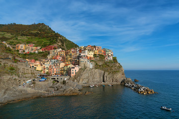Magnificent daily view of the Manarola village in a sunny summer day. Manarola is one of the five famous villages in Cinque Terre (Five lands) National Park. Liguria, Italy, Europe