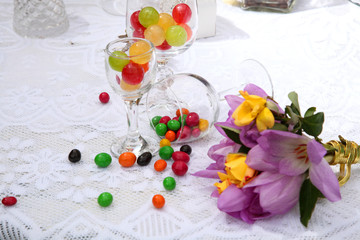 A festive table decorated with birthday cake with flowers and sweets. A table with a cake for the birthday of the child. Birthday party for children.