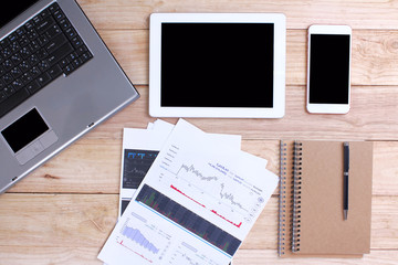 Home office for business Smartphone and a tablet and a laptop on the wooden background