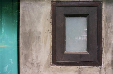 Old cement wall with a window.