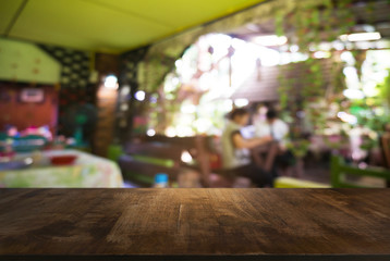 Empty wooden table in front of abstract blurred background of coffee shop . can be used for display Mock up  of product