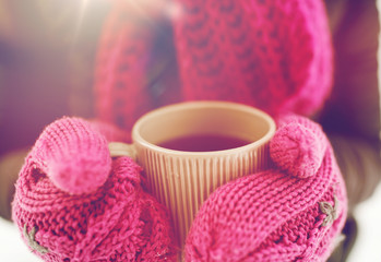 close up of woman with tea mug outdoors in winter