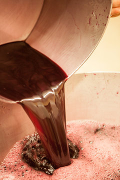 Close up of wine pouring into container