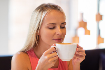 close up of woman drinking coffee at restaurant