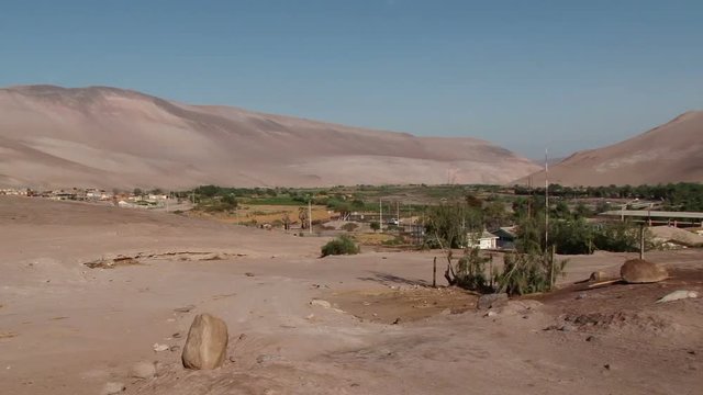 Wide shot of small village in valley at Arica-Parinacota region, Chile