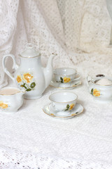 Obraz na płótnie Canvas Antique floral tea set on white background