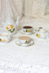 Vintage porcelain coffee cups with hot espresso and molk and retro on white table