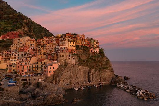 Magnificent sunset view of the Manarola village. Manarola is one of the five famous villages in Cinque Terre (Five lands) National Park. Liguria, Italy, Europe