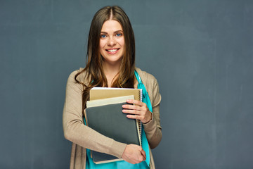 Smiling student or teacher holding books.