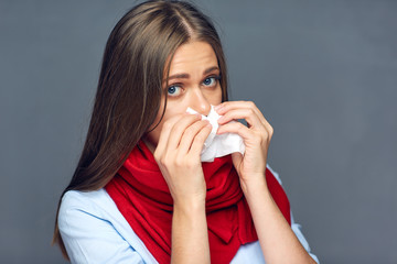 Sickness woman blow on nose in paper tissue.