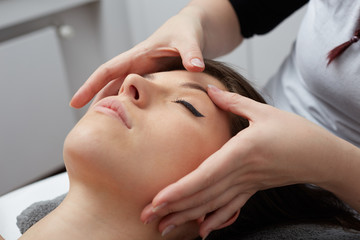 Fototapeta na wymiar Female Enjoying Relaxing Back Massage In Cosmetology Spa Center