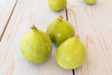 Portion of fresh figs on vintage wooden background.