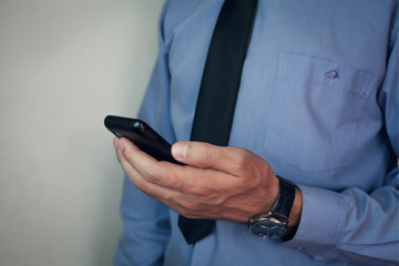 Businessman holding phone.