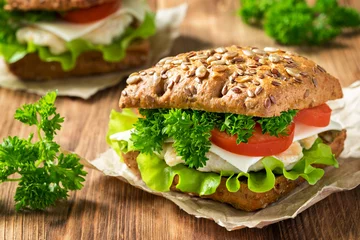 Foto op Canvas Homemade sandwich with chicken, fresh vegetables and herbs. Close-up. © Татьяна Кочкина
