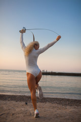 fencer training with a sword by the sea