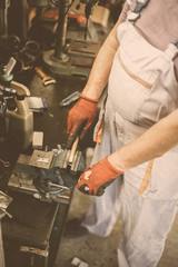 Senior man in workshop. Man cut on machine wood material. Close up.