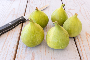 Portion of fresh figs on vintage wooden background.