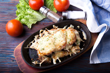 Baked Meat and cheese with vegetables on a pan