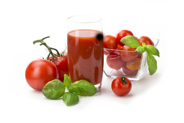 Tomato juice, tomatoes with basil in a glass isolate
