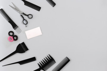 Hairdresser set with various accessories on gray background