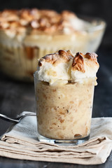 Homemade banana pudding with Meringue made from scratch over a rustic dark background. Extreme shallow depth of field with selective focus.