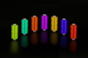 spool of thread on a black background