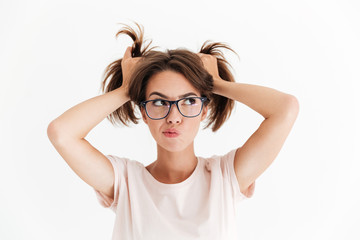 Fototapeta premium Pensive pretty woman in eyeglasses holding hair and looking away