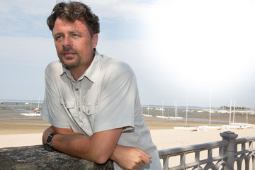 Side portrait of active middle age man relax by the sea