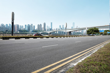 empty asphalt road with modern buildings in blue sky