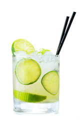 front view of cold fresh tropical cocktail in whiskey glass with a slice of lime, ice cubes, straws isolated on white background